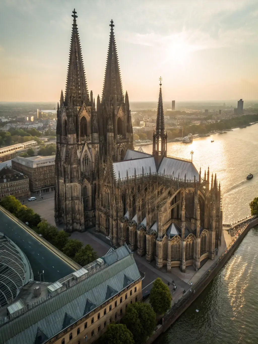 A photograph of the Cologne Cathedral, highlighting its Gothic architecture and intricate details, taken from a vantage point that shows the bustling city around it, during a Mass Excursions excursion.